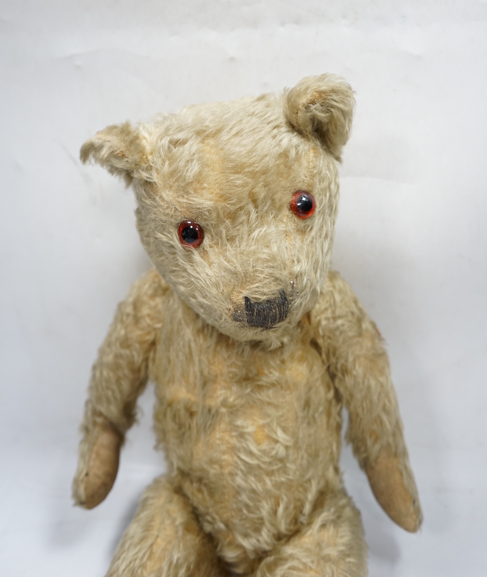 A 1930’s English Teddy bear, gold mohair plush and glass eyes, 49cm. Condition - fair